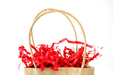 Close up of a gift bag with red ribbons isolated on a white background.の写真素材