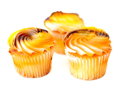 Autumn colored cupcakes isolated on white.の写真素材