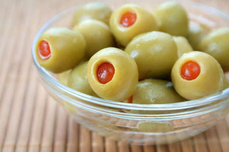 Bowl full of olives on a bamboo background.の写真素材