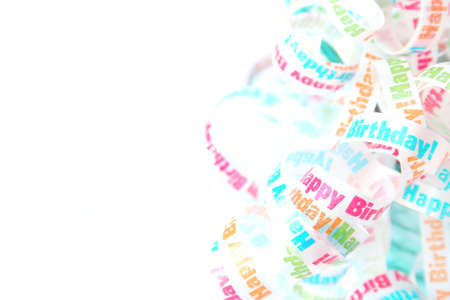 Birthday ribbon on a white background. Used a selective focus along with a shallow depth of field.の写真素材