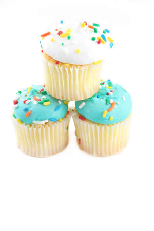 three cupcakes stacked like a Pyramid on a white background with room for text.の写真素材
