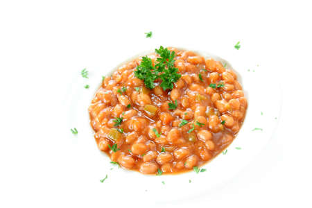 Baked beans with fresh parsley on a white background.の写真素材