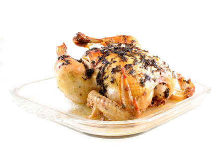 Whole chicken fresh out of the over and covered with fresh herbs. Room for your text.の写真素材