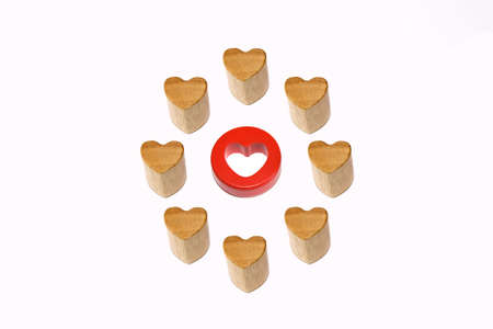 One red heart surrounded by eight wooden heartsの写真素材