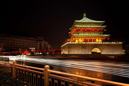 A dramatic long exposure of the Drum tower in Xian China with the lights of vehicles flowing in front.のeditorial素材