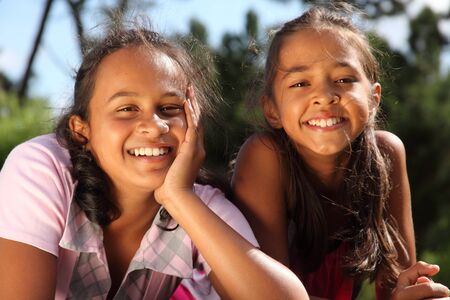 Smiling school girls enjoying a sunny dayの写真素材