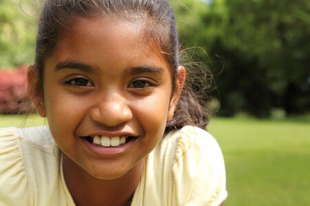 Pretty school girl in the park relaxed cheerful on sunny dayの写真素材