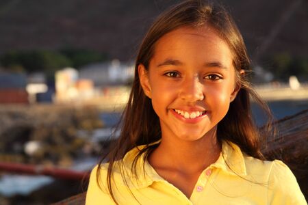Cutest smile in late afternoon light from young school girlの写真素材