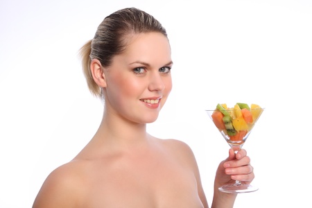 Healthy mixed fruit cocktail in glass for beautiful young blonde caucasian woman.の写真素材