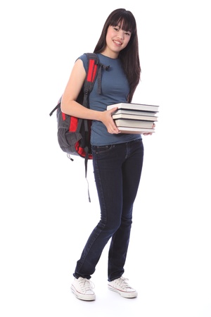 Carrying education books a beautiful smiling young Japanese teenager high school student girl wearing blue denim jeans and t-shirt, backpack over her shoulder.の写真素材
