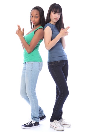 Two beautiful teenage friends, a mixed race african american and oriental Japanese girls having fun in a serious secret agent pose with fingers out imitating hand guns.の写真素材
