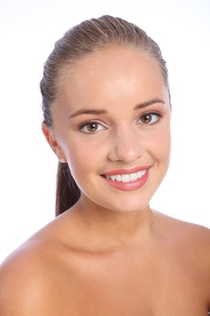Brilliant happy smile headshot of beautiful young cheerful caucasian woman with brown eyes, taken against white background.の写真素材