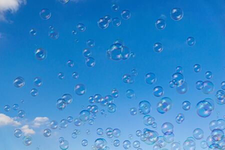 Bubbles floating in the sky on a summers dayの写真素材
