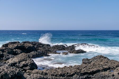 Atlantic ocean waves crashing over volcanic lava rocks on La Palma Island, Canary Islands, Spainの写真素材
