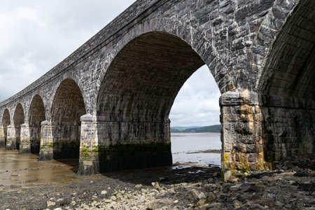 Mud flats underneath the railway bridge crossing the River Tavy at low tide, north of Plymouth,...