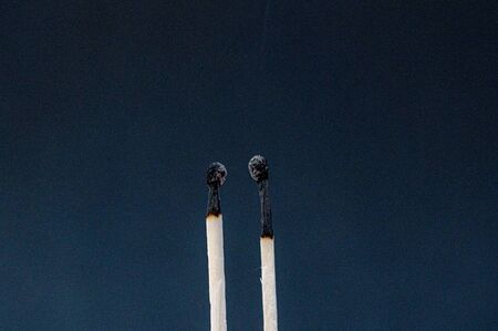 Two charred match sticksの写真素材