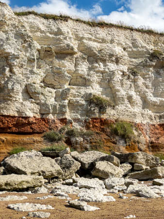 Red and white striped cliffs at Hunstanton, Norfolk, caused by layers of different coloured rockの写真素材