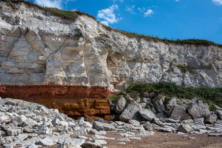 Red and white striped cliffs at Hunstanton, Norfolk, caused by layers of different coloured rockの写真素材