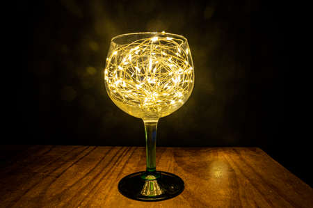 Festive golden Christmas light in a glassの写真素材