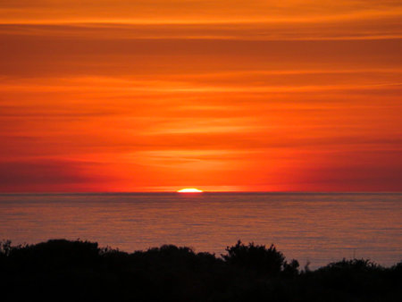 Dawn sunrise over the Mediterrean Ocean from Punta Prima, Menorcaの写真素材