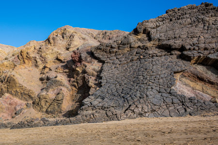Ventifact rock formations caused by wind at La Pared Beach, Fuerteventura, Spainの写真素材