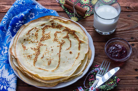 Pancakes on a plate with milk and ruspberry jamの写真素材