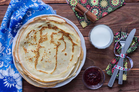 Pancakes on a plate with milk and ruspberry jamの写真素材