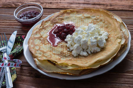 Pancakes on a plate with cottage cheese and ruspberry jamの写真素材