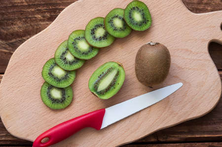 The ripe kiwifruits on the cutting boardの写真素材