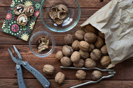 Walnuts on the wooden table and the accessories