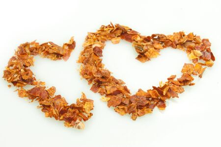 dried chili pepper in the shape of the heartの写真素材