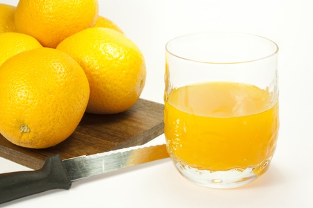 oranges and orange juice in a glassの写真素材