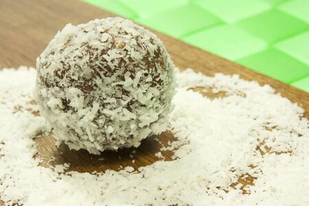 sweet chocolate balls covered in coconut flakes の写真素材