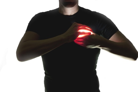 silhouette of man holding a luminous heartの写真素材