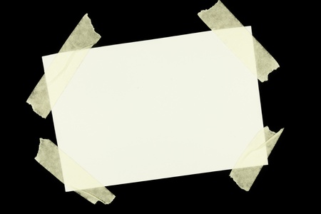 white sheet of paper with scotch on black background