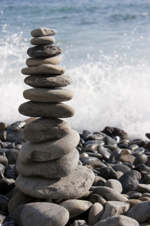 stack of pebbles in balance with the sea backgroundの写真素材