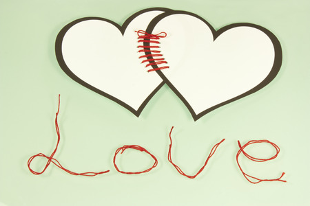 two hearts tied with love red threadの写真素材