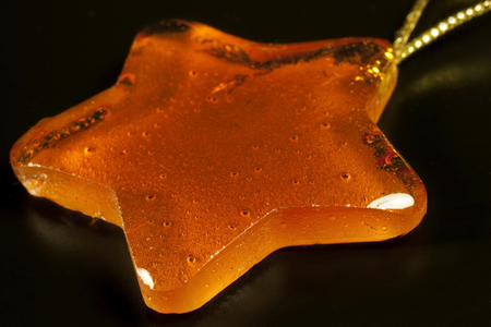 decoration depicting a star in plant resin or amberの写真素材