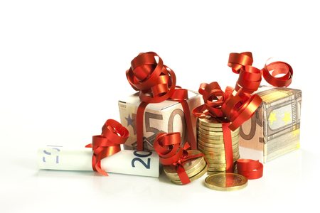 euro banknotes and coins wrapped as a giftの写真素材