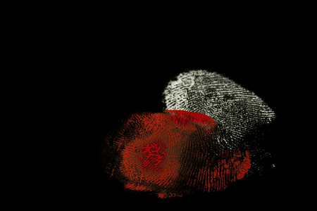 fingerprints white and red on black backgroundの写真素材