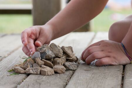 child playing with stonesの写真素材