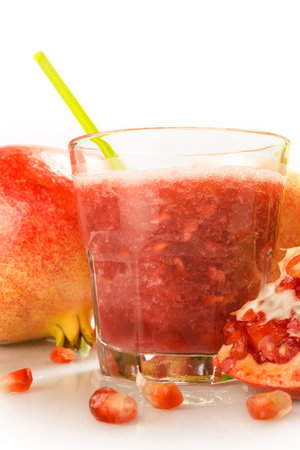 glass containing milky juice juice with fruit in evidenceの写真素材