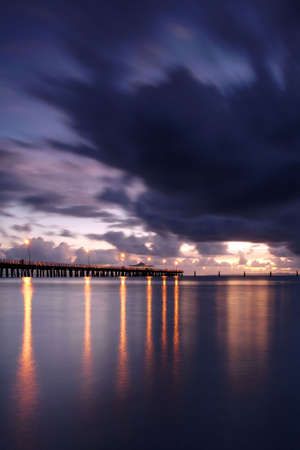 The sunset light is fading over the pierの写真素材