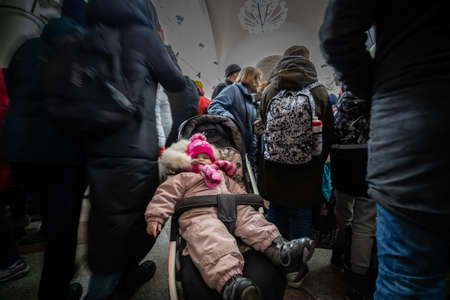 Dnipro, Ukraine - Mar 1, 2022 railway station, aid, refugee, child, stroller, chaos, queue, people, families, mother, woman, children, waiting, humanitarian, tent, evacuationのeditorial素材