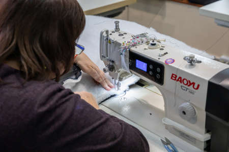 Dnipro, Ukraine - Mar 16, 2022 Workshop, woman, sew, dress, war, production, sleeping bag, jacket, sweatshirt,のeditorial素材