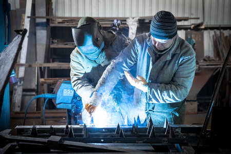 Dnipro, Ukraine - Mar 16, 2022 Workshop, welder, sparks, hood, fire, war, production, defenseのeditorial素材