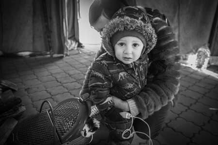 Dnipro, Ukraine - Mar 12, 2022 railway station, aid, refugees, queue, people, families, mother, child, fear, tears, cat, animal, waiting, humanitarian, tent, evacuationのeditorial素材