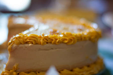close-up detail of the yellow greasing of a cake