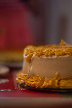 profile cake with yellow and white frosting