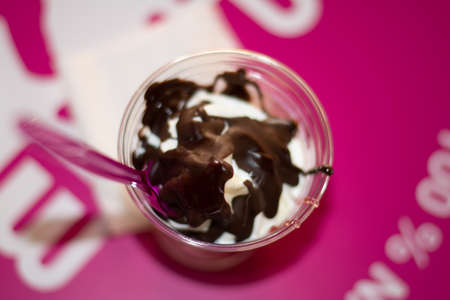 white frozen yogurt with black chocolates viewed from above